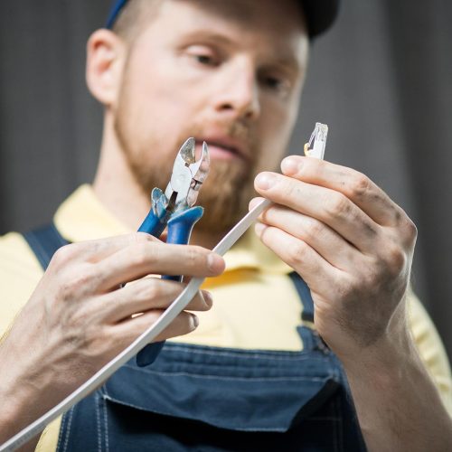 man-checking-power-cable-CNDU3R7-3.jpg